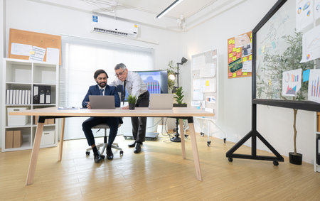 In a contemporary office, two senior executives with a mission to brainstorm and monitor the progress of a business projectの写真素材