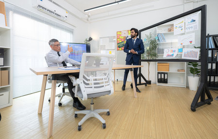 In a contemporary office, two senior executives with a mission to brainstorm and monitor the progress of a business projectの写真素材