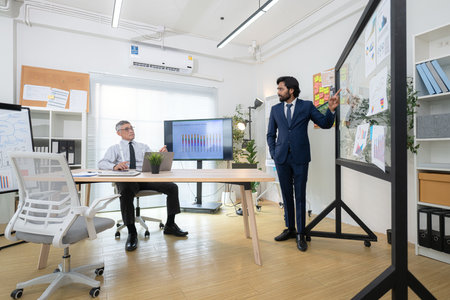In a contemporary office, two senior executives with a mission to brainstorm and monitor the progress of a business projectの写真素材