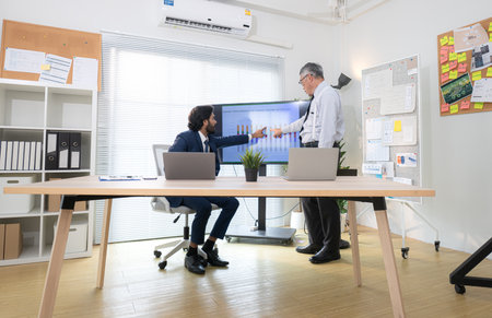 In a contemporary office, two senior executives with a mission to brainstorm and monitor the progress of a business projectの写真素材