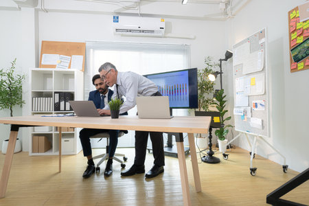 In a contemporary office, two senior executives with a mission to brainstorm and monitor the progress of a business projectの写真素材