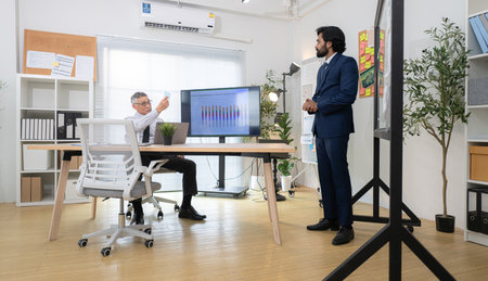 In a contemporary office, two senior executives with a mission to brainstorm and monitor the progress of a business projectの写真素材