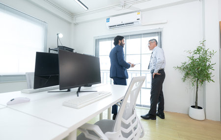 In a contemporary office, two senior executives with a mission to brainstorm and monitor the progress of a business projectの写真素材