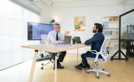 In a contemporary office, two senior executives with a mission to brainstorm and monitor the progress of a business projectの写真素材