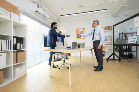 In a contemporary office, two senior executives with a mission to brainstorm and monitor the progress of a business projectの写真素材