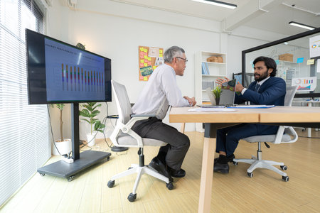 In a contemporary office, two senior executives with a mission to brainstorm and monitor the progress of a business projectの写真素材