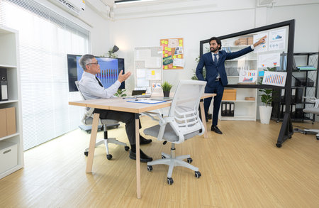 In a contemporary office, two senior executives with a mission to brainstorm and monitor the progress of a business projectの写真素材