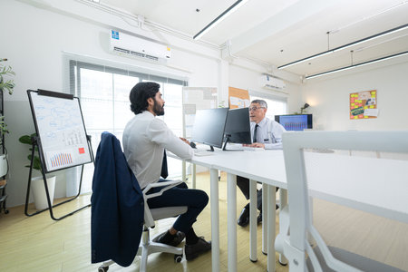 In a contemporary office, two senior executives with a mission to brainstorm and monitor the progress of a business projectの写真素材