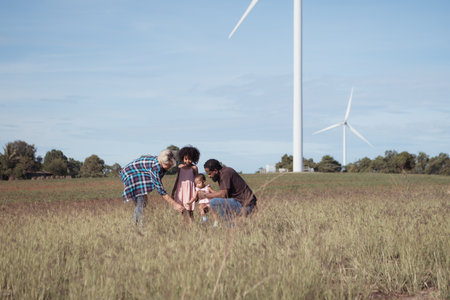 Family vacation with outdoor activities in the wind turbine fieldの写真素材