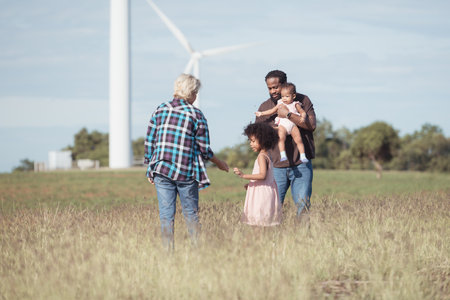 Family vacation with outdoor activities in the wind turbine fieldの写真素材