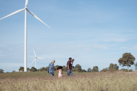 Family vacation with outdoor activities in the wind turbine fieldの写真素材