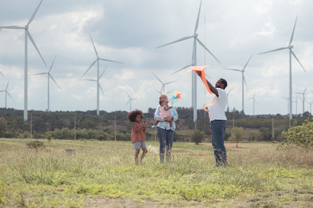 Family vacation with outdoor activities in the wind turbine fieldの写真素材