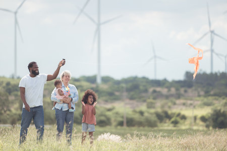 Family vacation with outdoor activities in the wind turbine fieldの写真素材