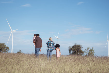 Family vacation with outdoor activities in the wind turbine fieldの写真素材