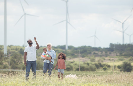 Family vacation with outdoor activities in the wind turbine fieldの写真素材