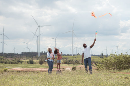 Family vacation with outdoor activities in the wind turbine fieldの写真素材
