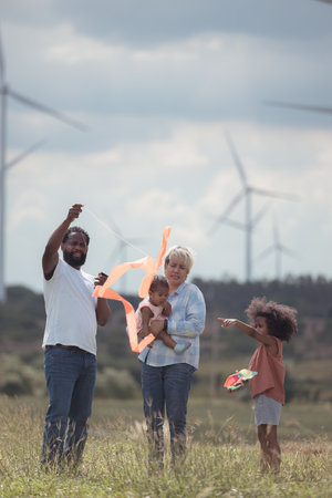 Family vacation with outdoor activities in the wind turbine fieldの写真素材