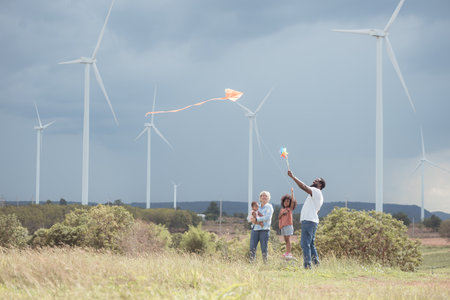 Family vacation with outdoor activities in the wind turbine fieldの写真素材