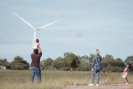 Family vacation with outdoor activities in the wind turbine fieldの写真素材