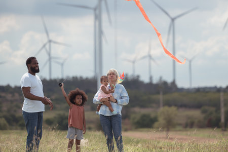 Family vacation with outdoor activities in the wind turbine fieldの写真素材