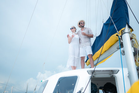 A young couple are enjoying seaside adventure aboard a yachtの写真素材