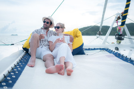 A young couple are enjoying seaside adventure aboard a yachtの写真素材