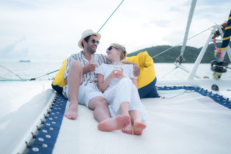 A young couple are enjoying seaside adventure aboard a yacht