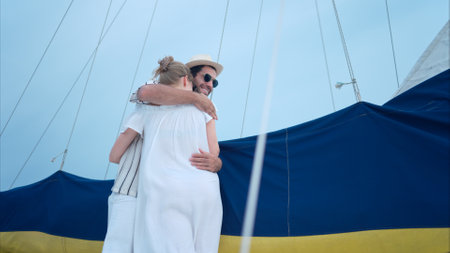 A young couple are enjoying seaside adventure aboard a yachtの写真素材
