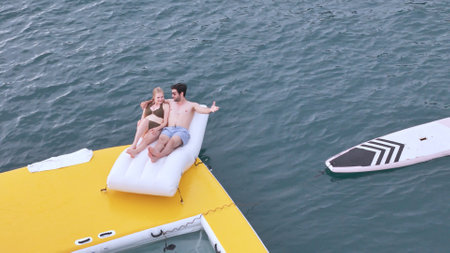 A young couple are enjoying seaside adventure aboard a yachtの写真素材