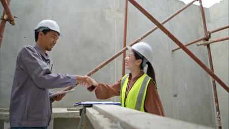 Engineers and architecture inspect and supervise the construction of building walls and foundations of residential buildingsの写真素材