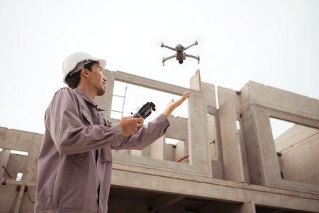 Engineers and survey aircraft on a mission to inspect residential building structuresの写真素材