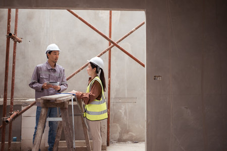 Engineers and architecture inspect and supervise the construction of building walls and foundations of residential buildingsの写真素材