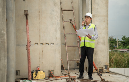 Engineers construction projects inspect and supervise the construction of building walls and foundations of residential buildingsの写真素材