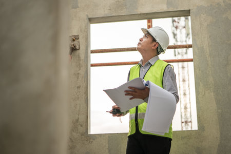 Engineers construction projects inspect and supervise the construction of building walls and foundations of residential buildingsの写真素材