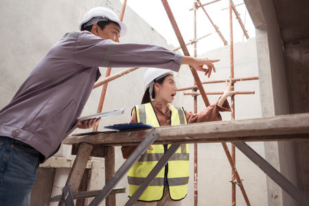 Engineers and architecture inspect and supervise the construction of building walls and foundations of residential buildingsの写真素材