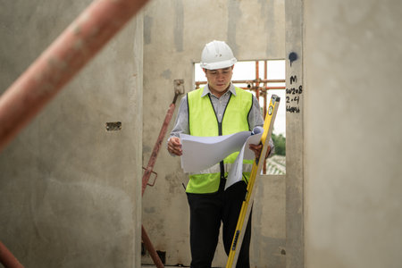 Engineers construction projects inspect and supervise the construction of building walls and foundations of residential buildingsの写真素材