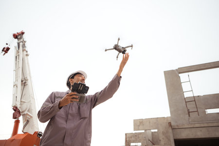 Engineers and survey aircraft on a mission to inspect residential building structuresの写真素材