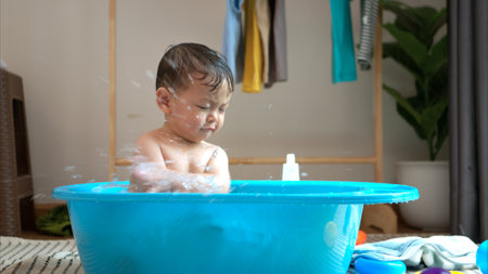 Mom and little child with taking a shower and dressing at home in the morningの写真素材