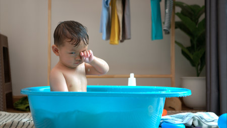 Mom and little child with taking a shower and dressing at home in the morningの写真素材
