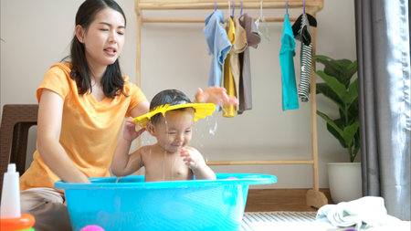 Mom and little child with taking a shower and dressing at home in the morning