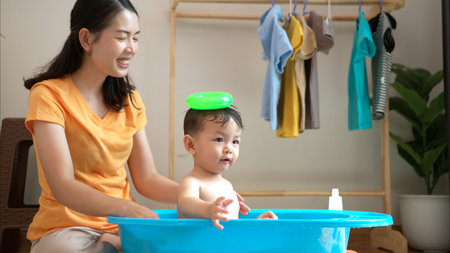 Mom and little child with taking a shower and dressing at home in the morning