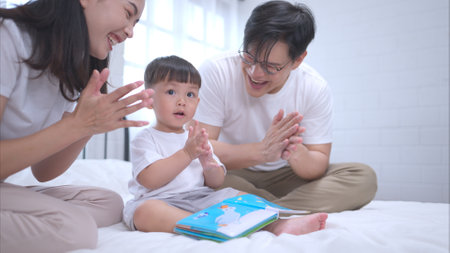 Before putting the kids to bed, parents, and kid unwind and play in the bedroomの写真素材
