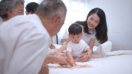 Before putting the kids to bed, parents, grandparents, and kid unwind and play in the bedroom