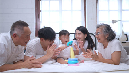 Before putting the kids to bed, parents, grandparents, and kid unwind and play in the bedroom
