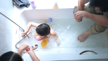 Happy time for bath, Asian kid and parents enjoying bath in the bathroomの写真素材