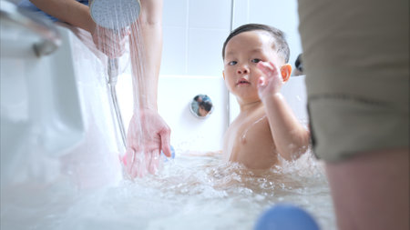 Happy time for bath, Asian kid and parents enjoying bath in the bathroomの写真素材