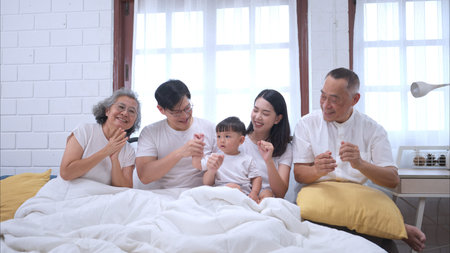 Before putting the kids to bed, parents, grandparents, and kid unwind and play in the bedroom