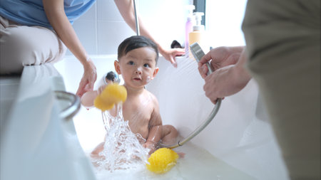 Happy time for bath, Asian kid and parents enjoying bath in the bathroomの写真素材