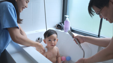 Happy time for bath, Asian kid and parents enjoying bath in the bathroomの写真素材