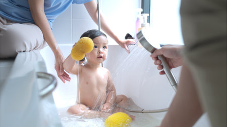 Happy time for bath, Asian kid and parents enjoying bath in the bathroomの写真素材